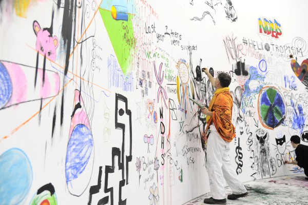 Pawel Althamer creates a drawing on the wall.