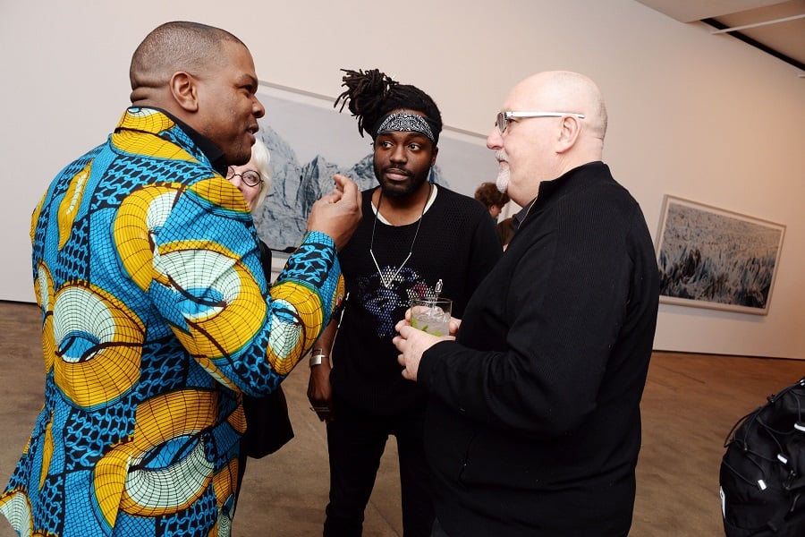 Kehinde Wiley, DJ MeLo-X and Sean Kelly chat at an opening for Frank Thiel at Sean Kelly Gallery. Photo - Clint Spaulding/PatrickMcMullan.com