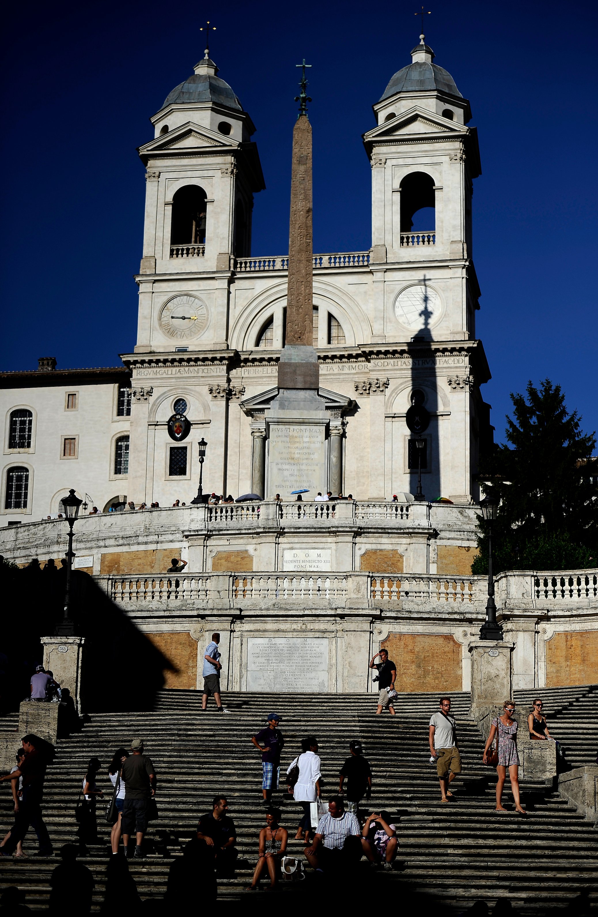 Tourists sit on the Spanish Steps in downtown Rome on August 1, 2010. Photo by Filippo Monteforte/AFP via Getty Images.