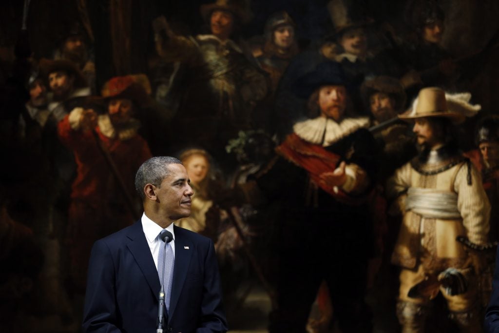 US President Barack Obama looks at the Dutch Prime Minister during a joint press conference held in front of Rembrandt's painting The Night Watch following meetings at the Rijksmuseum, the State Museum, in Amsterdam, on March 24, 2014. Photo AFP PHOTO/ POOL/Jerry Lampen via Getty Images.
