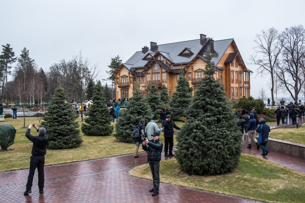 People wander around President Viktor Yanukovych's Mezhyhirya estate, which was abandoned by security, on February 22, 2014 in Kyiv, Ukraine. Ukrainian members of parliament have voted to oust Yanukovych. Photo by Brendan Hoffman/Getty Images.