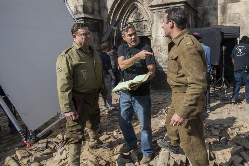 George Clooney, John Goodman and Jean Dujardin on the set of The Monuments Men (2014). Photo: Claudette Barius, courtesy Columbia Pictures Industries, Inc. and Twentieth Century Fox Film Corporation.