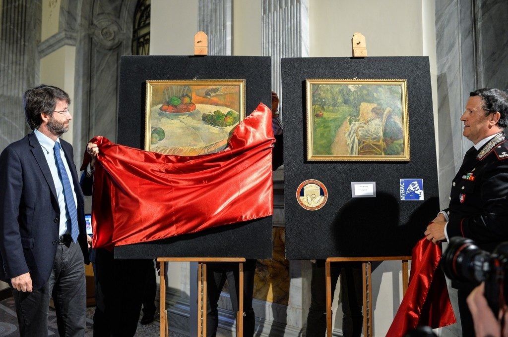 The recovered Paul Gauguin and Pierre Bonnard paintings being unveiled by Italian officials. The current owner, a factory worker, hopes the artwork will be returned to him. Photo: Andreas Solaro, courtesy Agence France-Presse/Getty Images.