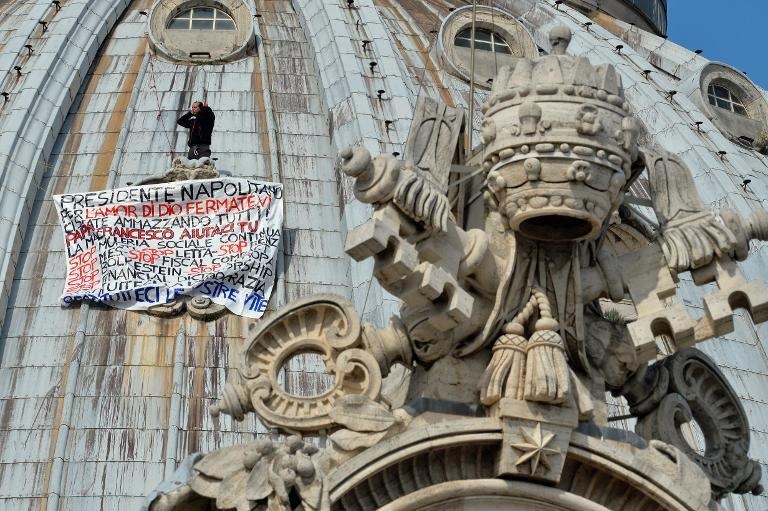 Marcello Di Finizio protesting the Italian government on the dome of St. Peter's basilica in Rome, March 30, 2014. Photo: Andreas Solaro, courtesy Agence France-Presse.