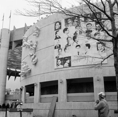 Andy Warhol, 13 Most wanted Men (1964), 20 by 20 foot mural  mounted on the curved facade of the New York State Pavilion at the 1964 New York World’s Fair in Flushing Meadow Corona Park, Queens, New York. The photo was taken in April, before mounting political pressure led to censors painting over the mural, which depicted mug shots of the NYPD’s 13 most-wanted criminals.  Photo: AP, courtesy the Andy Warhol Foundation for the Visual Arts, Inc. and the Artists Rights Society.