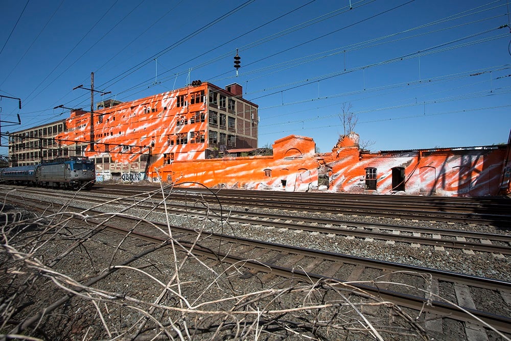 Katharina Grosse,<em> psychylustro</em> (2014), one of seven sites along Amtrak's Northeast corridor transformed by the artist. Photo: Steve Weinik, courtesy the City of Philadelphia Mural Arts Program.
