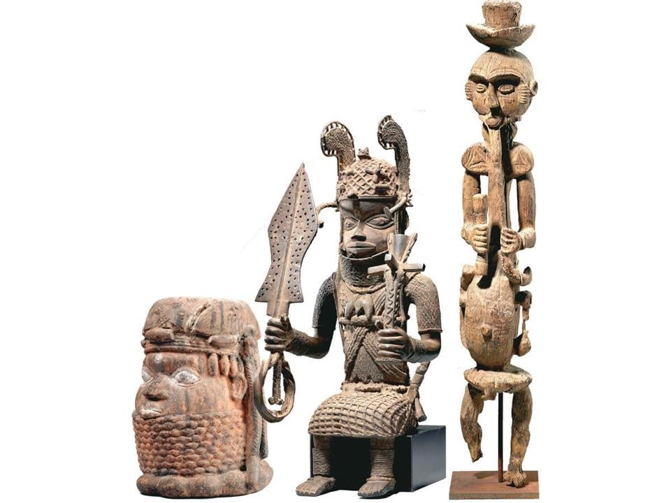 From left, a nineteeth-century terra-cotta head; a brass figure that was part of an altar dedicated in 1914 that was probably stolen from the royal palace in Benin City; a four-foot tall wooden figure that was in Nigeria's Oron Museum until at least 1970. The three works are among 8 donated to the museum by William and Bertha Teel that have been returned to their native Nigeria. Photo: courtesy the Museum of Fine Arts, Boston.