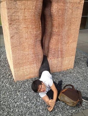 An American student waiting for firefighters to free him from Fernando de la Jara's marble vagina sculpture, Chacán-Pi (Making Love), at Germany's Tübingen University. Photo: Erick Guzman, via Imgur.