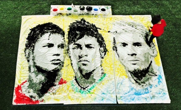 Red Hong Yi paints a portrait of World Cup soccer stars Cristiano Ronaldo, Neymar and Lionel Messi using her feet and a soccer ball. Photo: courtesy Red Hong Yi.