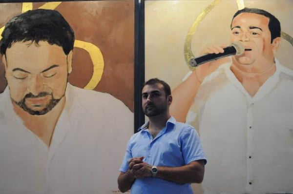 George Mihal Vasilescu in the Museum in Bucharest, standing in front of two of his works. Photo: Lucian Muntean via Artists for Roma
