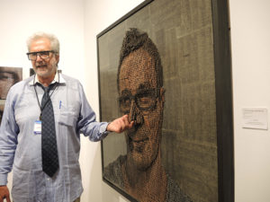 Gallerist Lawrence Cantor with a 3D screw painting by Andrew Myers at ArtHamptons. Photo: Sarah Cascone.