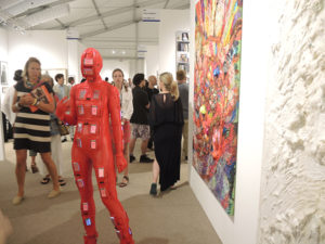 A visitor wears a iPhone covered body suit with flashing messages at ArtHamptons. Photo: Sarah Cascone.