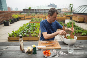 Jon Kessler making a salad as part of Julia Sherman's artist-made salad interview series hosted at the MoMA PS1 Salad Garden in Queens, New York. Photo: Julia Sherman.