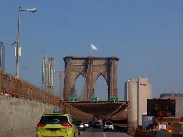 One lane of traffic was stopped during the police investigation of the white flags hoisted to the top of New York's Brooklyn Bridge overnight. Photo: Mark S. Weprin, via Twitter.