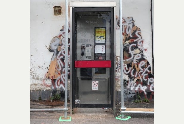Banksy, Spy Booth (2014), now vandalized. Photo: via Western Daily Press.