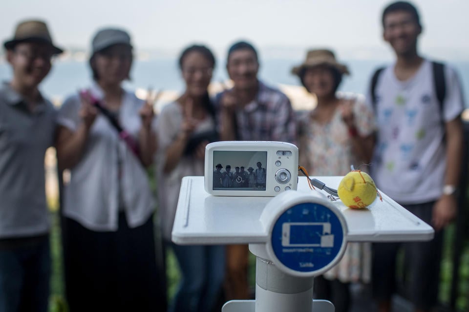 A group of people using a selfie stand on Enoshima Island in Fujisawa, Japan. Photo: Chris McGrath, courtesy Getty Images.