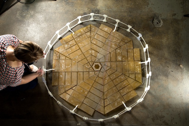 Shannon Zirbel with the unfolded prototype for a solar panel array designed for NASA using origami techniques. Photo: Mark A. Philbrick, courtesy Brigham Young University.
