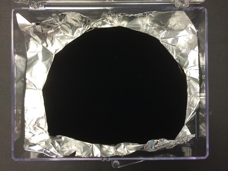 A sample of Vantablack. The material is so dark it makes crinkled aluminum foil appear flat. Photo by Surrey NanoSystems Creative Commons Attribution-Share Alike 3.0 Unported license.