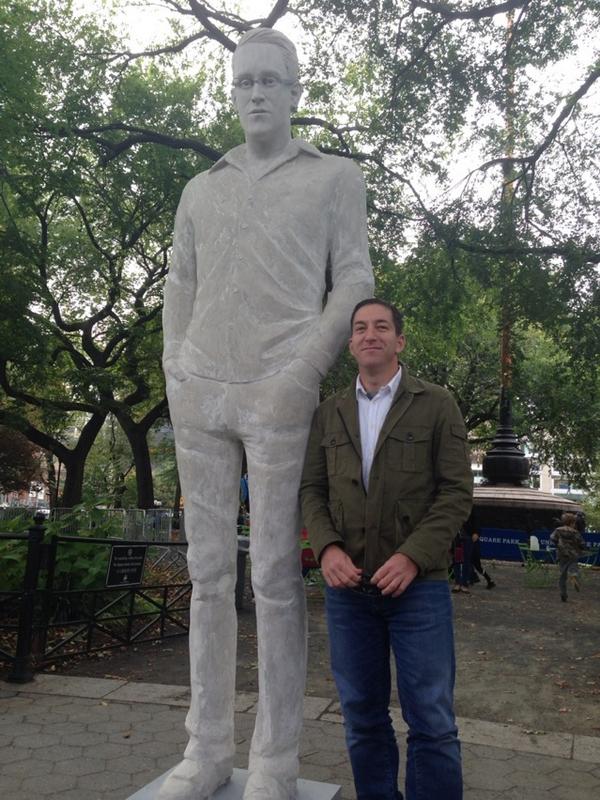 Journalist Glenn Greenwood, who helped Edward Snowden blow the whistle on the NSA, poses with a statue of the fugitive by Jim Dessicino in Union Square during New York's Art in Odd Places. Photo: Jeremy Scahill, via Twitter. 