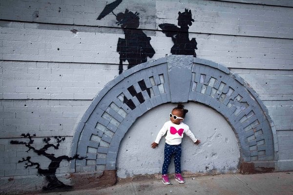 A girl poses with Banksy's Japanese footbridge. Photo: Carlo Allegri