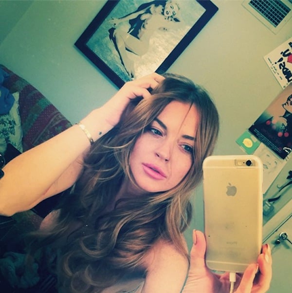 Lindsay Lohan, taking a selfie in her dressing room, with the Pegasus portrait behind<br>Photo: @lindsaylohan