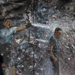 A painting at a Hong Kong protest site shows riot police using pepper spray against pro-democracy demonstrators. Photo: AFP.