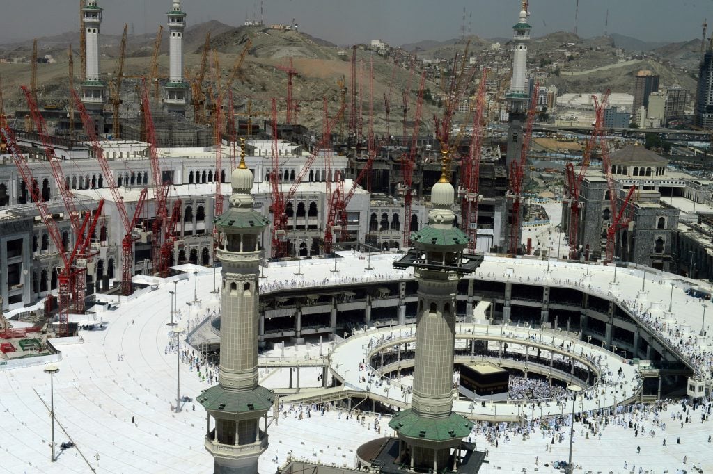 Muslim pilgrims from all around the world circumambulate the Kaaba, the Muslim's holiest shrine, during the constructions for extension project of the Mataf, the open area around the Kaaba, continues at Masjid al-Haram (the Grand Mosque) in the Muslim holy city of Mecca, Saudi Arabia on October 1, 2014. Photo by Dilek Mermer/Anadolu Agency/Getty Images.