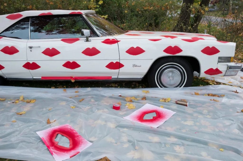 Donald Robertson and Smashbox <em>#BingtoBasel</em>  mobile art project featuring a 1974 Cadillac covered in red lipstick lip prints. Photo courtesy of Smashbox Cosmetics.