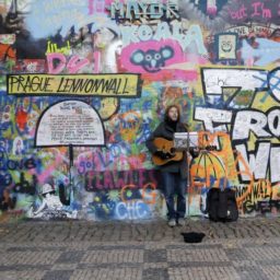 A street musician plays in front of the John Lennon Wall in Prague (2014). Photo: Petr David Josek, courtesy AP Photo.