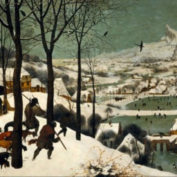 A group of figures followed by dogs walking across a snowy landscape, with a bustling village in the background.