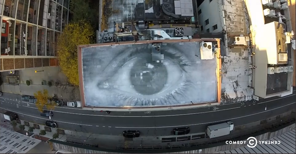 JR, mural of Stephen Colbert's eye on the roof of the studio where <em>The Colbert Report</em> was filmed. Photo: screen shot via Comedy Central.