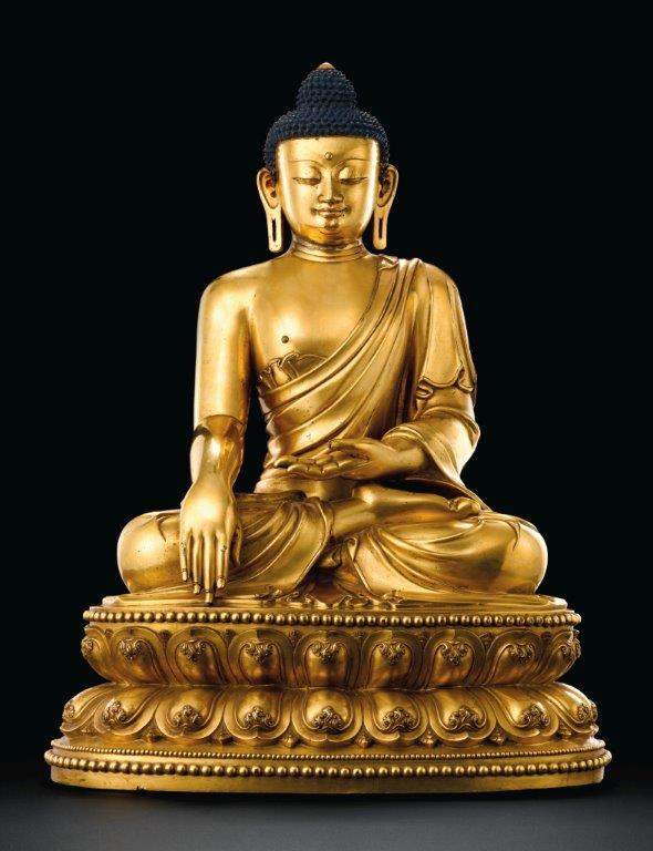 An outstanding and highly important massive gilt-bronze figure of a seated Shakyamuni Buddha
