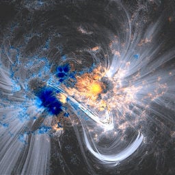 "Solar material traces out giant magnetic fields soaring through the sun to create what's called coronal loops. Here they can be seen as white lines in a sharpened AIA image from October 24, 2014, laid over data from SDO's Helioseismic Magnetic Imager, which shows magnetic fields on the sun's surface in false color." Photo: NASA/SDO/HMI/AIA/LMSAL﻿.