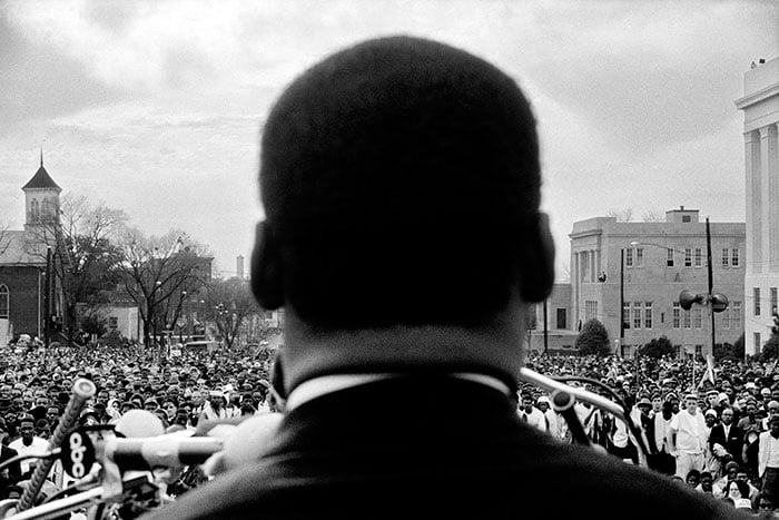 Stephen Somerstein, Martin Luther King Jr. looking out at the crowd at Montgomery. Now recreated in the Selma movie poster, the photographer snapped this shot by taking advantage of the moment. 