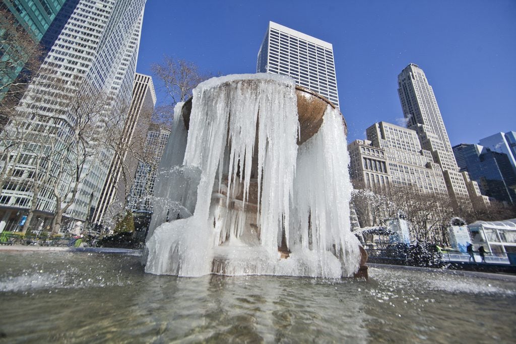 The Bryant Park fountain covered in ice. Photo by Anthony Quintano, Flickr Creative Commons.