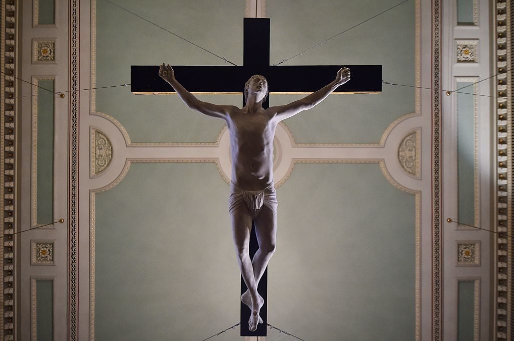 A life-size marble statue titled 'For Pete's Sake' depicting British singer Pete Doherty on a crucifix by artists Reynolds and Schoony hangs from the ceiling of St Marylebone Parish Church as part of a temporary exhibition 'Stations of the Cross' in London on February 19, 2015. The sculpture was originally made in 2008 as collaboration between Pete Doherty and artist Nick Reynolds. The exhibition 'Stations of the Cross' will be open to the public until March 17, 2015. Photo credit should read BEN STANSALL/AFP/Getty Images.