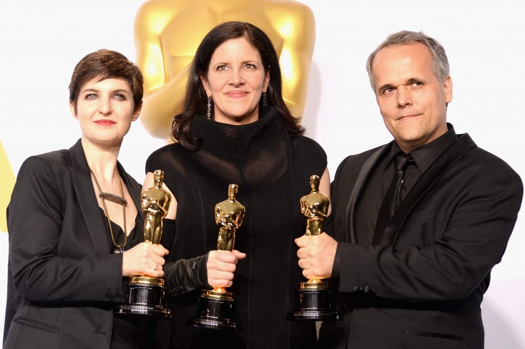 Mathilde Bonnefoy, Laura Poitras, and Dirk Wilutsky with the Academy Award for best documentary feature for their film Citizenfour during the 87th Annual Academy Awards at Loews Hollywood Hotel on February 22, 2015 in Hollywood, California. Photo by Jeff Kravitz/FilmMagic.