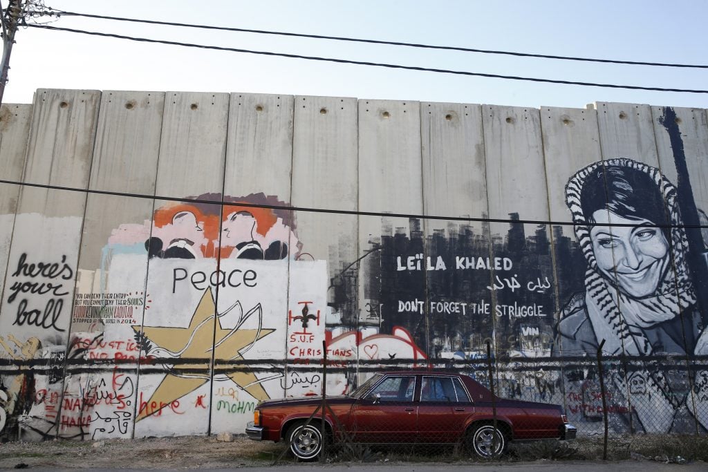 Tags and graffiti on the Israel West Bank security barrier. Photo by Godong/Universal Images Group via Getty Images.