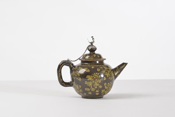 A rare brown-glazed Delft spherical teapot and cover with silver mount (1700-10). Marked LVD for Lieve Van Dalen The Young Moor's Head Factory from 1695-1715 . Photo: Courtesy Aronson Antiquairs, Amsterdam