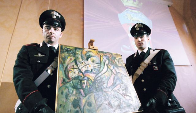 Police with a fake painting by Wassily Kandinsky. Photo: Alberto Cattaneo, courtesy Agenzia Fotogramma.