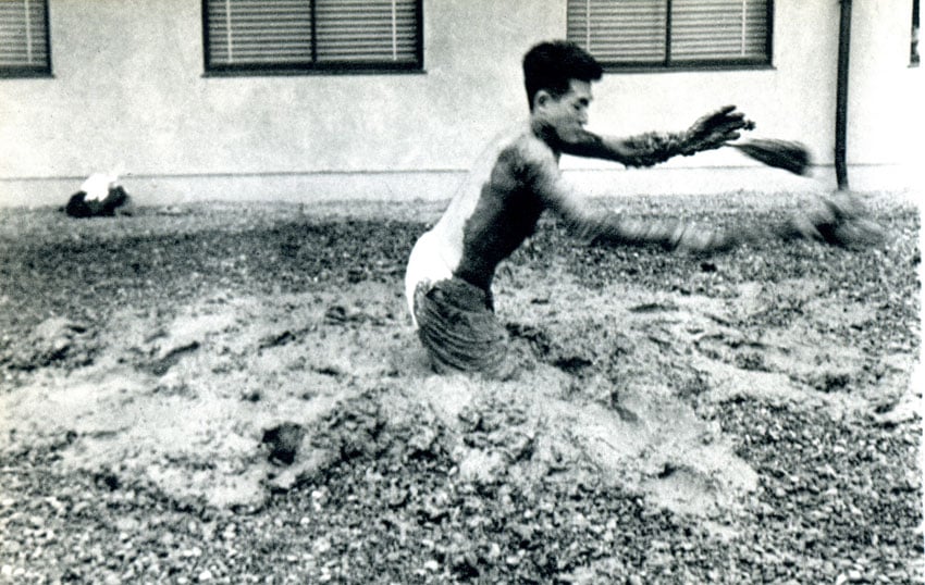 Photo documenting Kazuo Shiraga performing <em> Challenging Mud</em> at the 1st Gutai Open Air Exhibition, Tokyo
