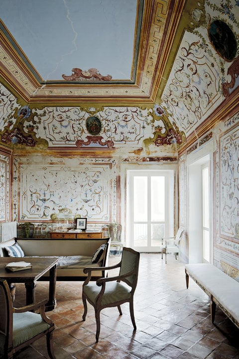 "The grand sitting room of the main house that dates from A.D. 1000, on the property of Nicola Del Roscio, Cy Twombly’s archivist and close companion, in Gaeta, Italy, with 18th-century frescoes thought to be by the artist Sebastiano Conca, a sofa from Andy Warhol’s home in Paris and terra-cotta tiles on the floor, handmade in a nearby village." Photo: Simon Watson/T Magazine