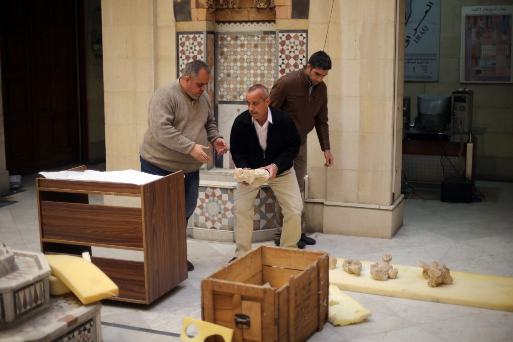 Damascus Museum employees wrap archaeological artifacts into boxes to protect them from being damaged on March 24, 2015, in the Syrian capital. Workers at Syria's National Museum of Damascus carefully wrap statues and place them in boxes to be transported to a safe place, hoping to save the priceless pieces from theft or destruction. Photo by Joseph Eid /AFP via Getty Images.