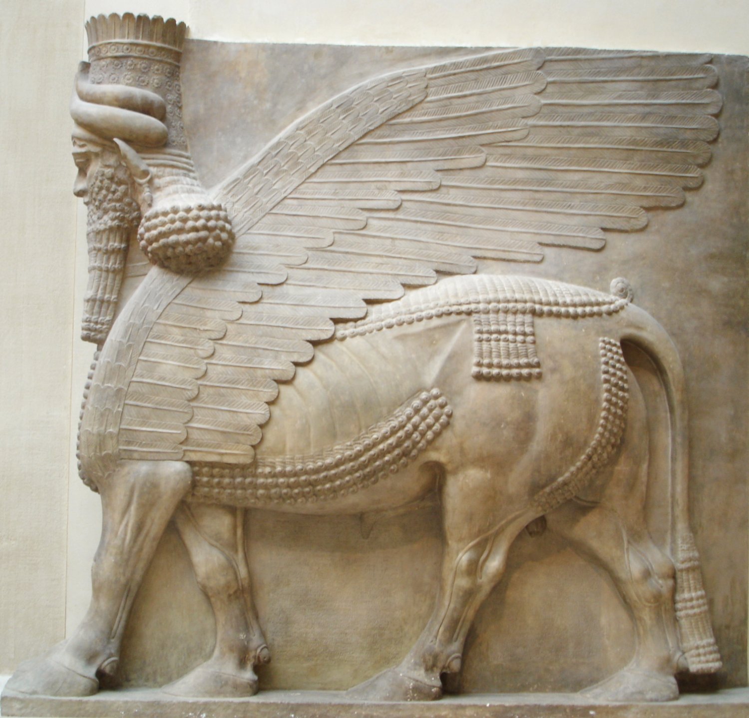 Lamassu (Human-headed winged bull) relief from tKing Sargon II's palace at Dur Sharrukin in Assyria, now in the collection of the Louvre in Paris. A head from a similar statue is among 65 looted artifacts the U.S. is repatriating to Iraq. Photo by Marie-Lan Nguyen, public domain.