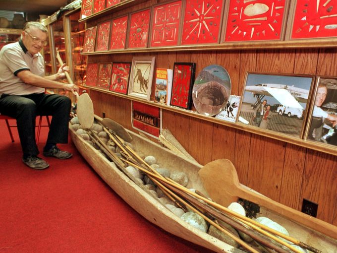 Don Miller with his collection, demonstrating how to use a paddle for a South American dugout canoe. Photo: Rob Goebel, courtesy the Indy Star.