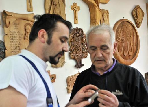 Muslim sculptor Edin Hajderovac, who is carving a chair for Pope Francis, at work in his studio in Zavidovici, Bosnia.  Photo: Elvis Barukcic, courtesy AFP Photo.