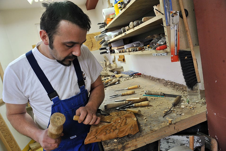 Muslim sculptor Edin Hajderovac, who is carving a chair for Pope Francis, with his father Salem in their studio in Zavidovici, Bosnia.  Photo: Elvis Barukcic, courtesy AFP Photo.