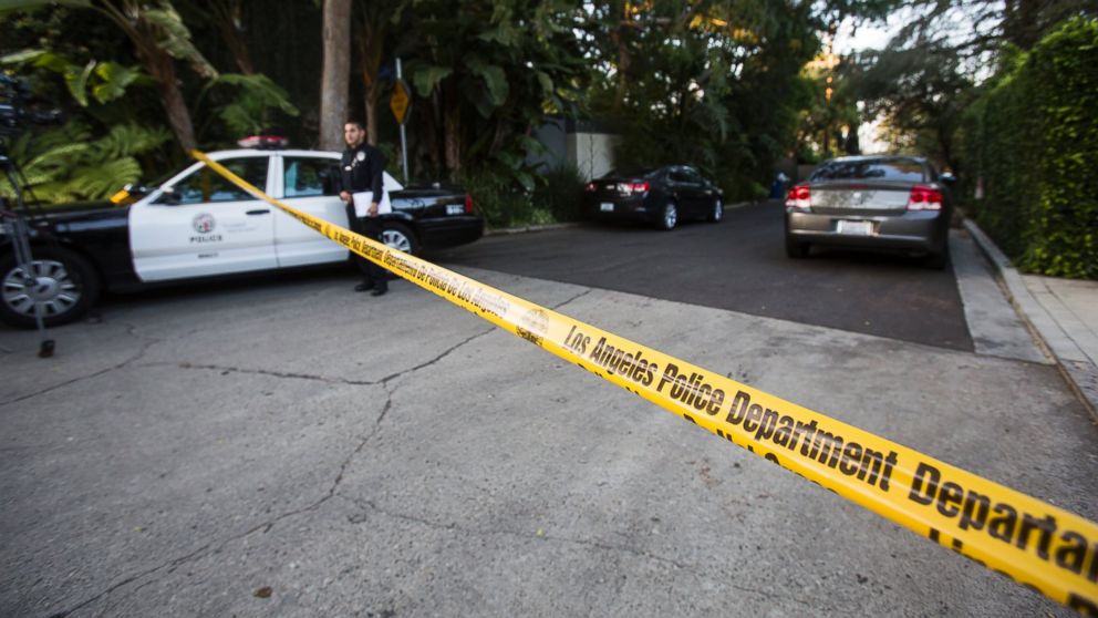 An officer stands outside the home of Andrew Getty in the Hollywood Hills. Photo: Ringo H.W. Chiu/AP Photo.
