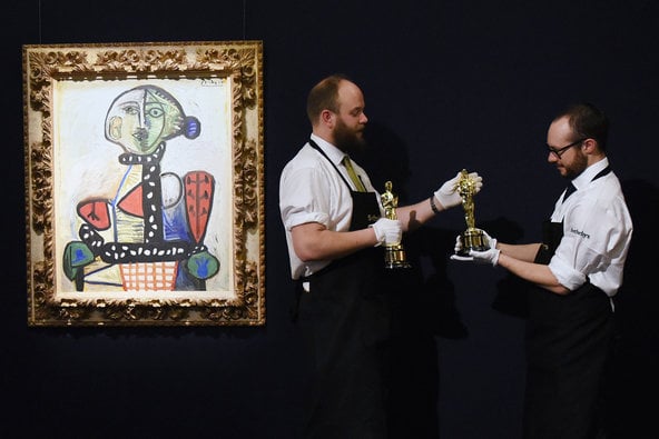 Pablo Picasso, <em>Femme au chignon dans un fauteuil</em> (1948), on display in April at Sotheby's office in London, alongside a pair of Oscars (not for sale).  Photo: Mary Turner/Getty Images for Sotheby's.