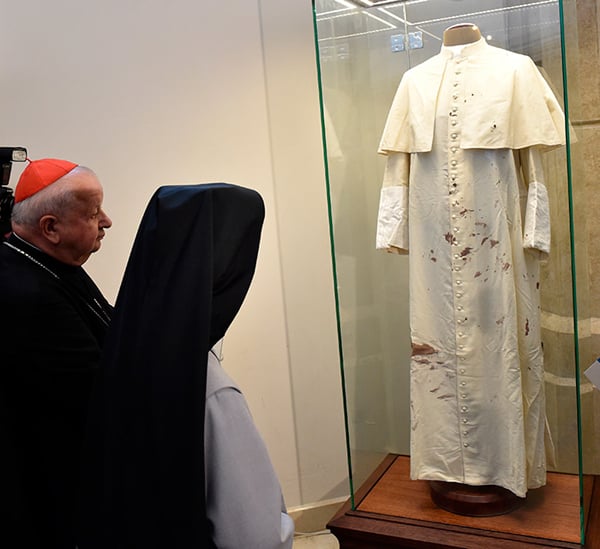 Cardinal Stanislaw Dziwisz with nun who took care of the pope, look on Pope John Paul II bloodied cassock at the Saint John Paul II Sanctuary in KraKow, Poland, on May 13, 2015. Photo: AFP Photo via ArtDaily.org